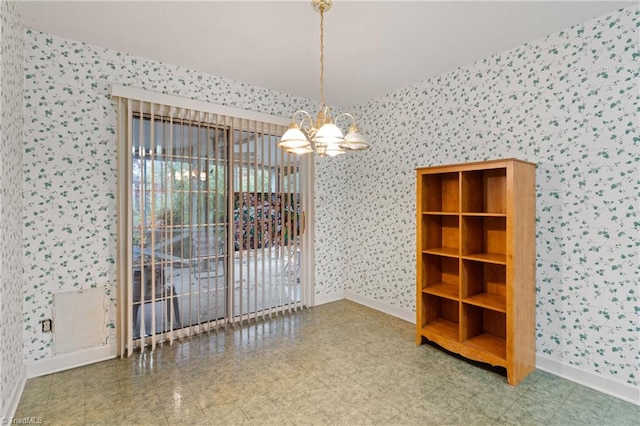 unfurnished room with a notable chandelier