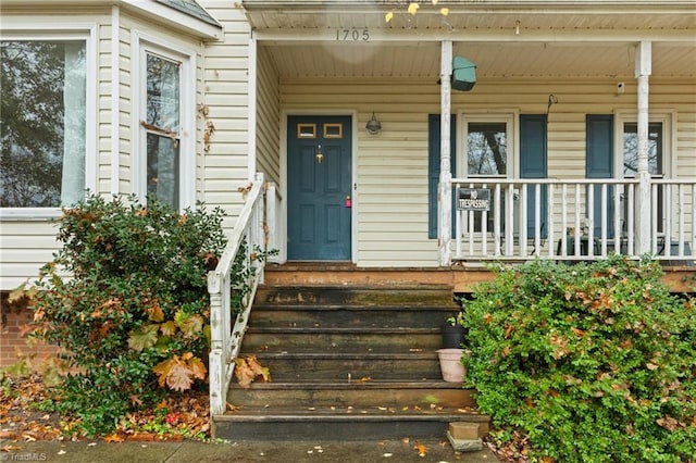 view of exterior entry with covered porch