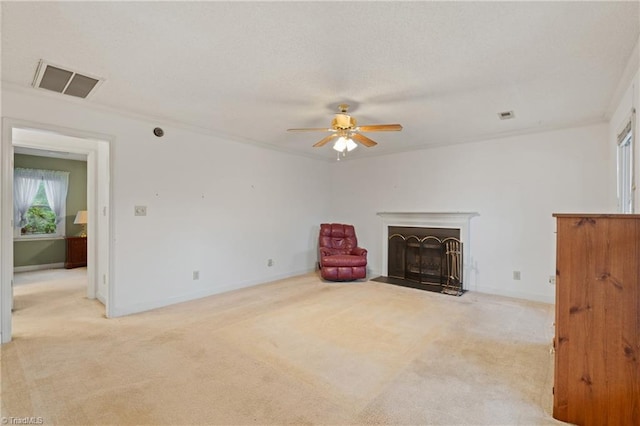 unfurnished room with ceiling fan, crown molding, and light colored carpet