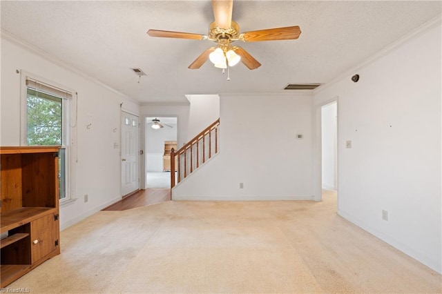 living room featuring ceiling fan, crown molding, and light carpet