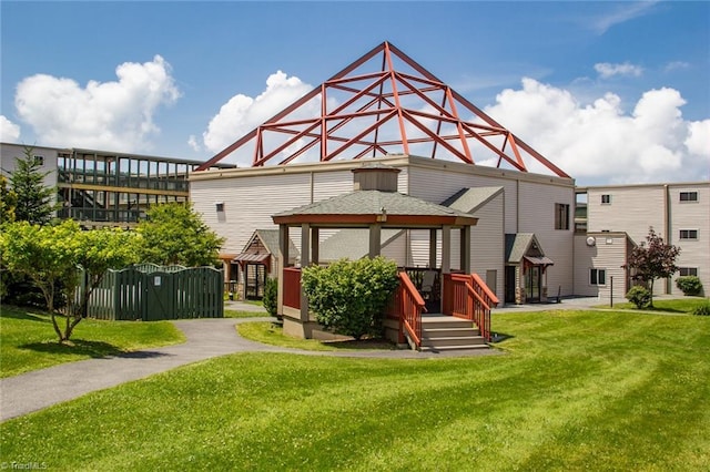 back of house with a gazebo and a lawn