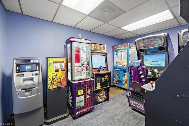 game room with a paneled ceiling and carpet floors