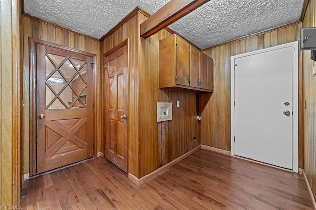 interior space featuring wood walls, wood-type flooring, and a textured ceiling