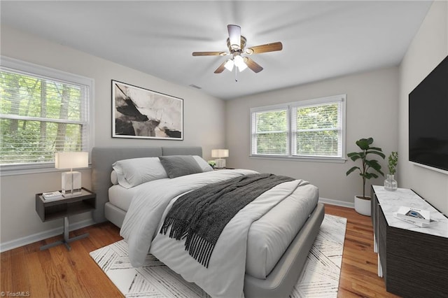 bedroom featuring hardwood / wood-style flooring and ceiling fan