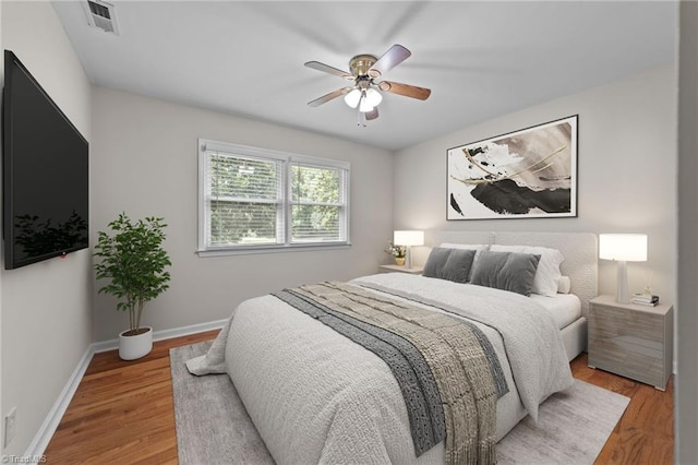 bedroom with ceiling fan and light hardwood / wood-style floors