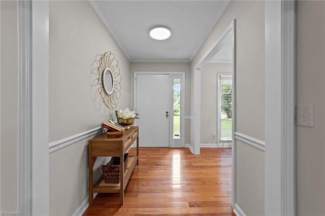 entrance foyer featuring crown molding and light hardwood / wood-style flooring