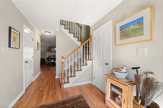 entryway featuring crown molding and hardwood / wood-style flooring