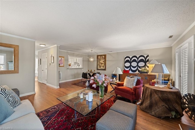 living room featuring a healthy amount of sunlight, a textured ceiling, and light wood-type flooring