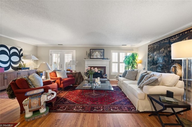 living room with crown molding, plenty of natural light, and wood-type flooring