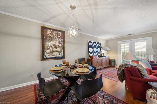 dining space with crown molding, dark hardwood / wood-style flooring, and a textured ceiling