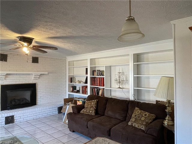 living room with light tile patterned floors, a fireplace, built in features, and a textured ceiling