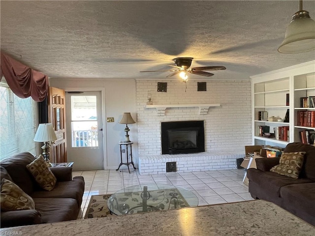 tiled living area with built in features, a fireplace, a textured ceiling, and ceiling fan