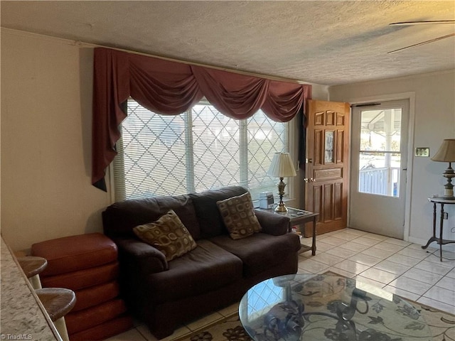 living room featuring a textured ceiling and light tile patterned flooring