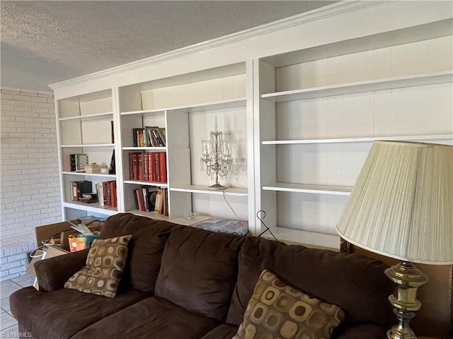 living room featuring a textured ceiling, built in shelves, tile patterned flooring, and crown molding