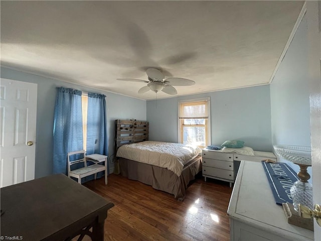 bedroom featuring dark wood-style floors, crown molding, and a ceiling fan