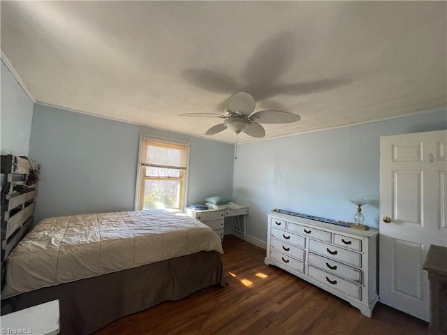 bedroom with dark wood-type flooring, ornamental molding, and ceiling fan