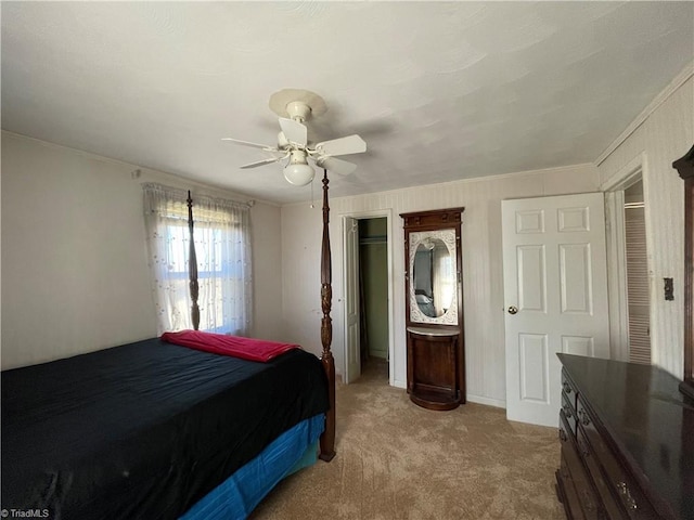 bedroom with light carpet, ceiling fan, and a closet