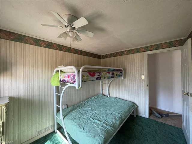 bedroom with a ceiling fan, carpet flooring, a textured ceiling, and baseboards