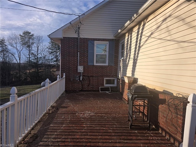 view of side of property with brick siding