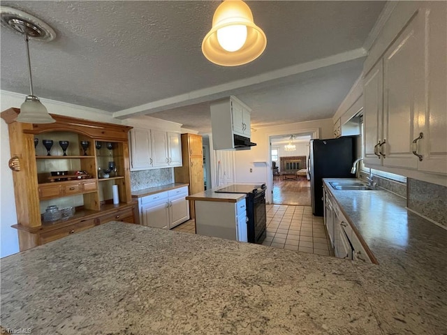 kitchen featuring white cabinets, decorative backsplash, a kitchen island, black / electric stove, and a sink