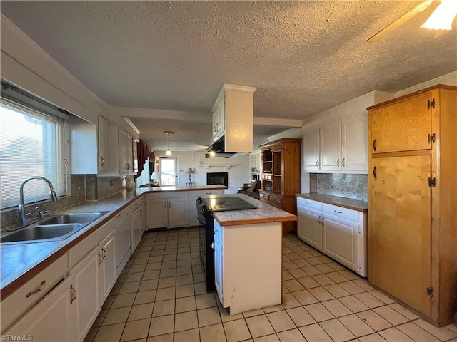 kitchen featuring decorative backsplash, light tile patterned flooring, a sink, black range with electric cooktop, and a peninsula