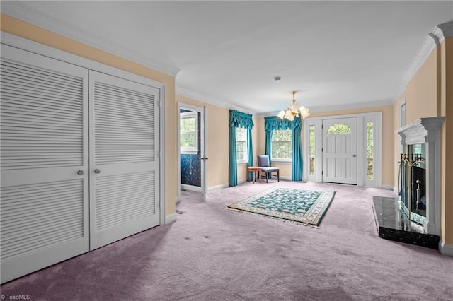 12088 Burlington Rd, Hurdle Mills, NC 27541 - carpeted entryway with crown molding, a chandelier, baseboards, a fireplace with raised hearth, and plenty of natural light