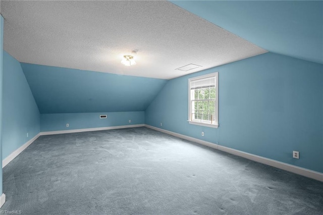 12088 Burlington Rd, Hurdle Mills, NC 27541 - bonus room featuring vaulted ceiling, carpet floors, baseboards, and a textured ceiling