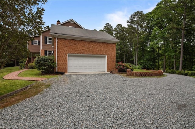 12088 Burlington Rd, Hurdle Mills, NC 27541 - view of property exterior featuring driveway, brick siding, a garage, and a chimney