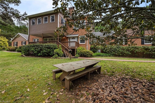 12088 Burlington Rd, Hurdle Mills, NC 27541 - back of house featuring brick siding, a wooden deck, a yard, and stairway