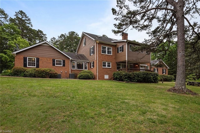 12088 Burlington Rd, Hurdle Mills, NC 27541 - rear view of property featuring brick siding, a lawn, central AC, and a chimney