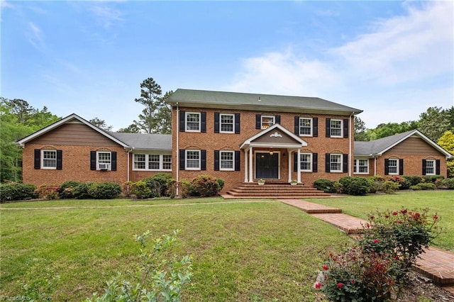 12088 Burlington Rd, Hurdle Mills, NC 27541 - colonial inspired home featuring a front lawn and brick siding