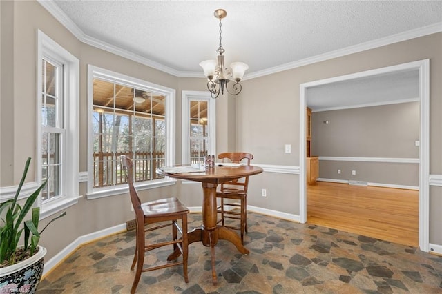 dining room featuring a chandelier, stone finish floor, a textured ceiling, and crown molding