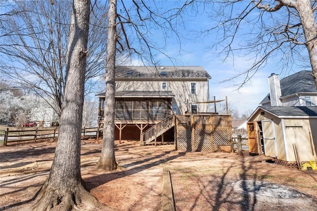 exterior space with stairs, fence, and a sunroom