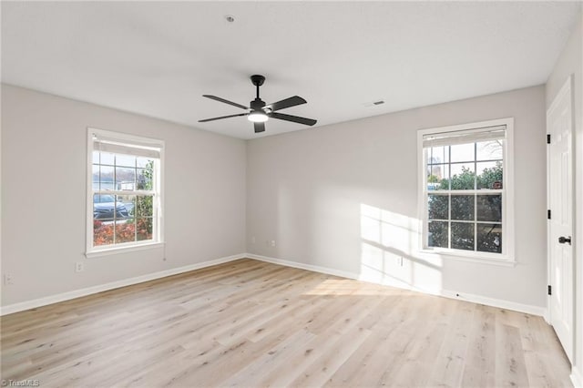 unfurnished room with ceiling fan, plenty of natural light, and light hardwood / wood-style flooring