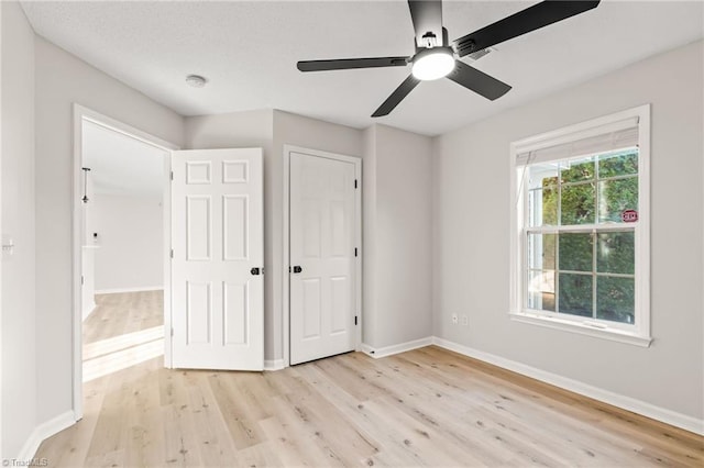 unfurnished bedroom with ceiling fan and light hardwood / wood-style floors