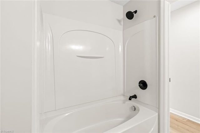 bathroom featuring shower / bathtub combination and hardwood / wood-style floors