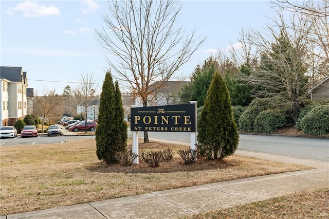 community / neighborhood sign with a lawn