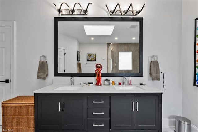 full bathroom featuring a sink, a skylight, a shower, and double vanity