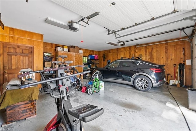garage with wooden walls and a garage door opener