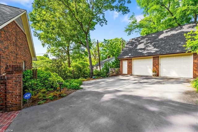 detached garage with concrete driveway