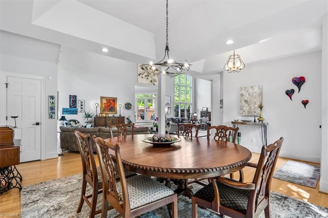 dining space with recessed lighting, a chandelier, and light wood-type flooring