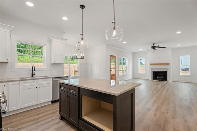 kitchen featuring stainless steel appliances, sink, plenty of natural light, hanging light fixtures, and white cabinets