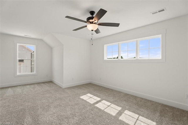 bonus room featuring ceiling fan and light colored carpet