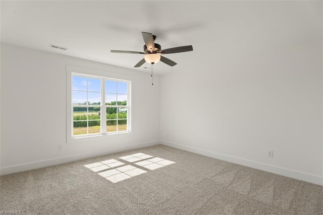 carpeted spare room with ceiling fan