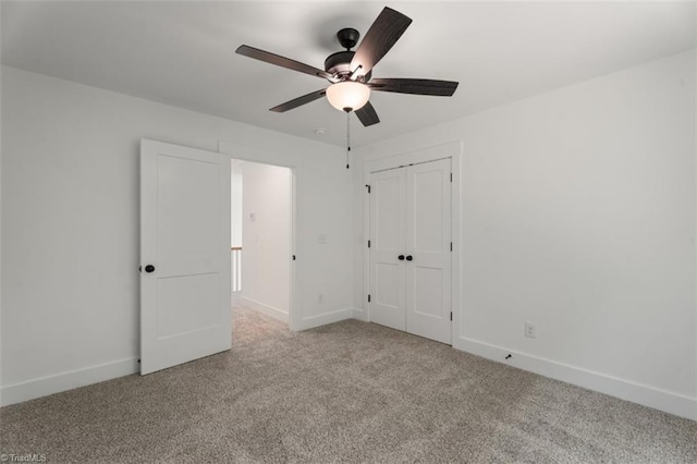 unfurnished bedroom with a closet, light colored carpet, and ceiling fan