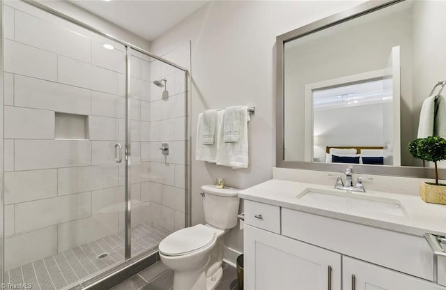 full bath featuring vanity, tile patterned floors, a stall shower, and toilet