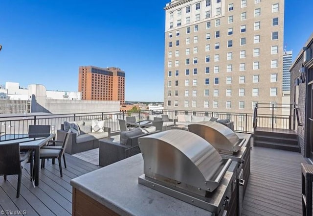 deck with area for grilling, outdoor dining area, an outdoor living space, a city view, and a grill