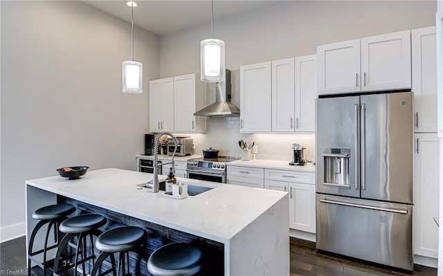 400 W 4th St Unit 401, Winston-Salem, NC 27101 - kitchen with dark wood-style flooring, a sink, wall chimney exhaust hood, tasteful backsplash, and appliances with stainless steel finishes