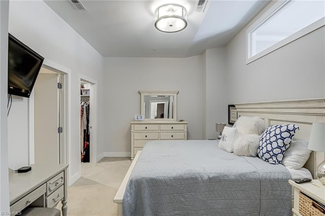 400 W 4th St Unit 401, Winston-Salem, NC 27101 - bedroom with a spacious closet, visible vents, and light colored carpet