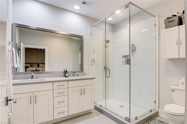 400 W 4th St Unit 401, Winston-Salem, NC 27101 - bathroom with toilet, visible vents, a stall shower, and a sink